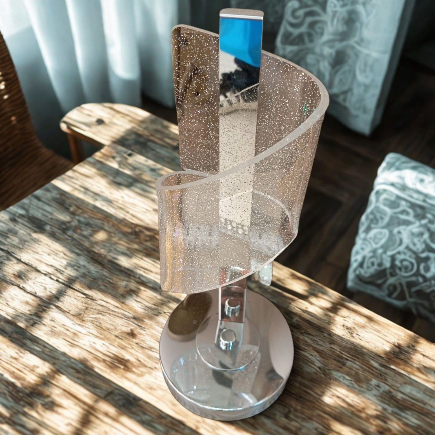 Decorative lamp with glittery shade on a wooden surface