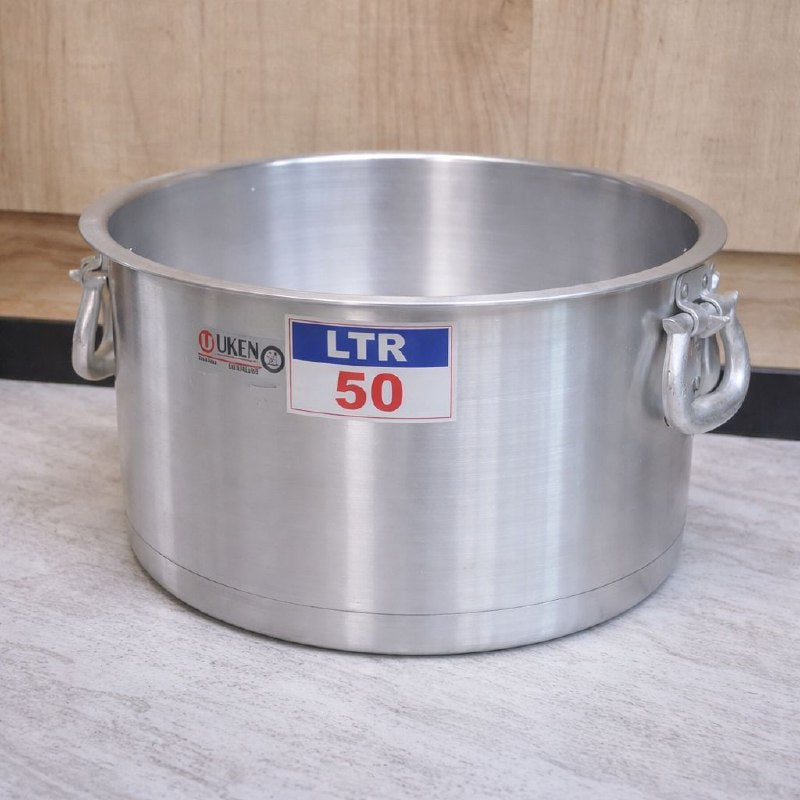 Large metallic pot with 'LTR 50' label on a wooden floor