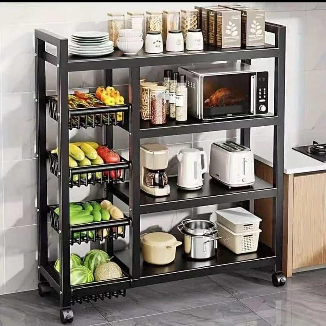 Black multi-tier kitchen storage rack with rolling wheels, wire baskets for fruits and vegetables, and open shelves for kitchen appliances including a microwave, toaster, and coffee maker