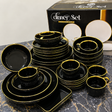 
Luxury black and gold rimmed ceramic dinner set including dinner plates, side plates, bowls, mugs, teacups and rectangular serving tray displayed on a marble surface with branded gift box — available at iDecorators Kenya, Nairobi.