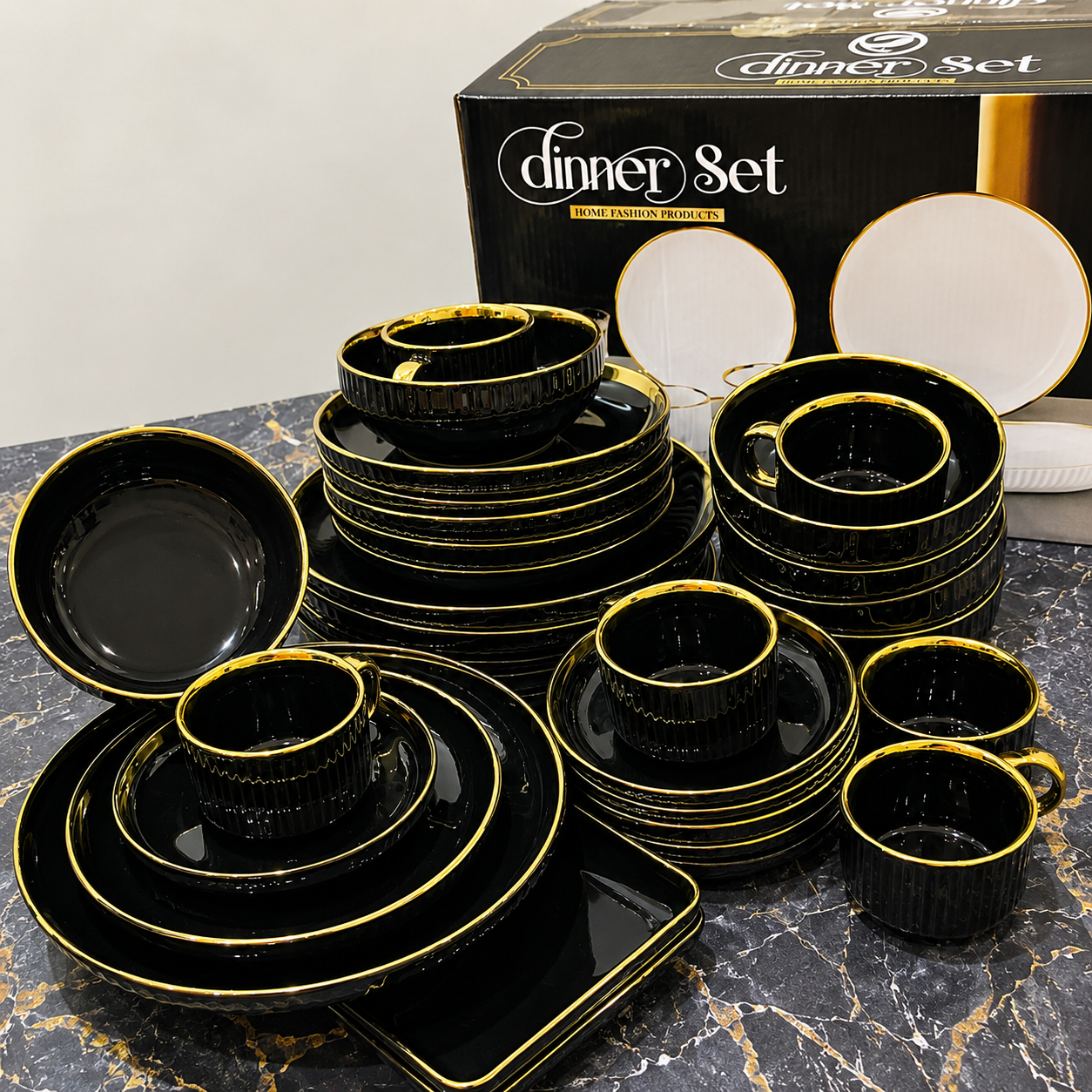 
Luxury black and gold rimmed ceramic dinner set including dinner plates, side plates, bowls, mugs, teacups and rectangular serving tray displayed on a marble surface with branded gift box — available at iDecorators Kenya, Nairobi.