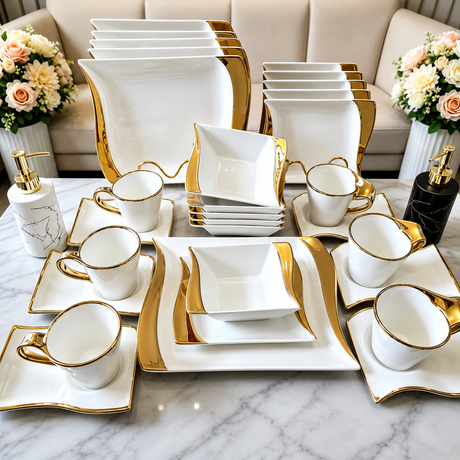 30-piece white and gold square porcelain dinner set with dinner plates, side plates, bowls, cups, and saucers displayed on a marble table.