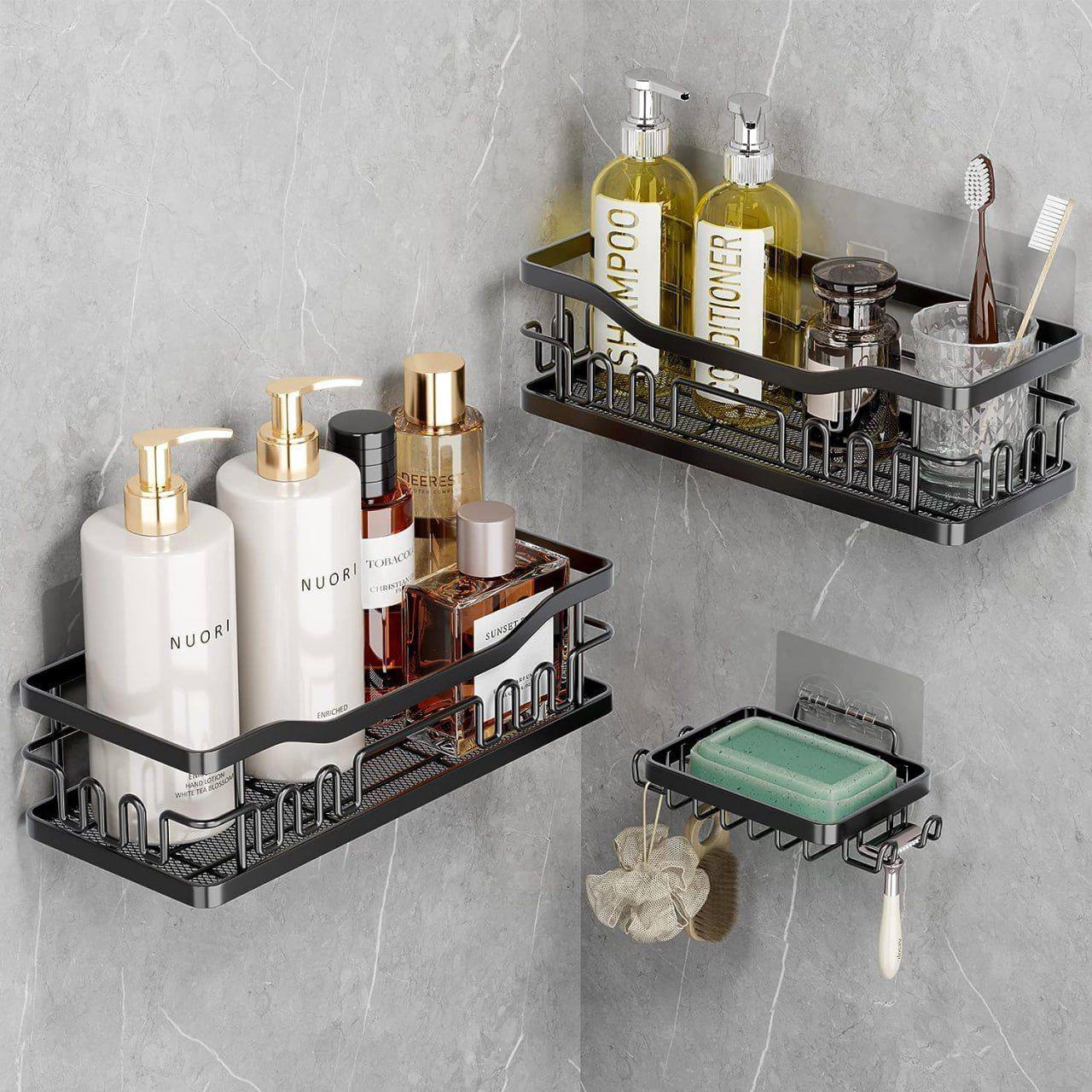 A set of black, rustproof metal shower caddy shelves mounted on a smooth wall, with various bathroom items organized on them.