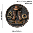 Round rustic wooden welcome wall sign featuring cowboy boots, cowboy hat, and rope accents for western farmhouse home décor.