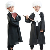 Kids dressed in black judge costume gowns with white curly wigs holding books for school role play and themed performances.