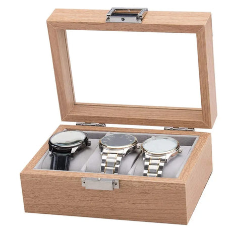 Wooden watch box with three watches inside on a white background